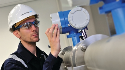 Service technician performing maintenance on process instrumentation